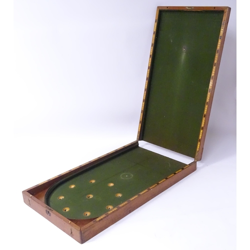 62 - A 19thC mahogany folding bagatelle / table billiards board, the interior with inset boxwood and ebon... 