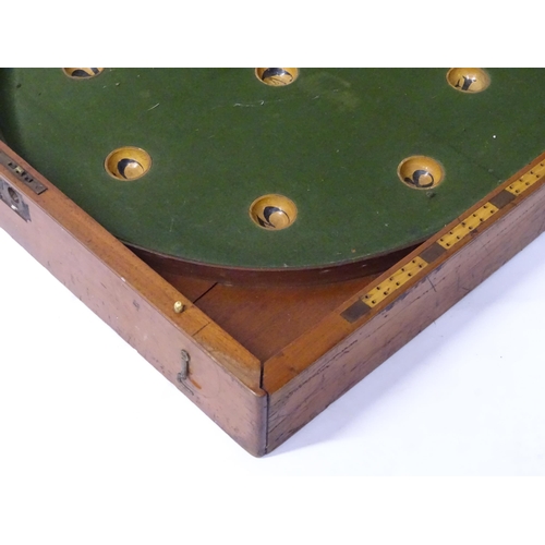 62 - A 19thC mahogany folding bagatelle / table billiards board, the interior with inset boxwood and ebon... 