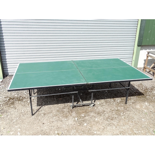 834 - A folding table tennis table with wheeled base, the top approx 108