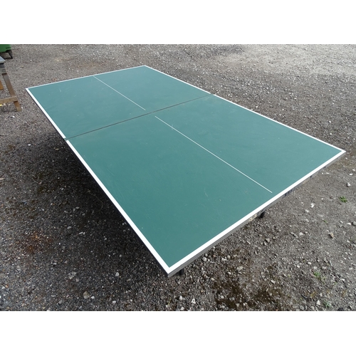 834 - A folding table tennis table with wheeled base, the top approx 108