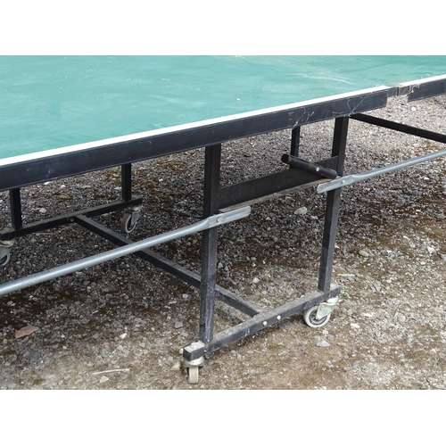 834 - A folding table tennis table with wheeled base, the top approx 108