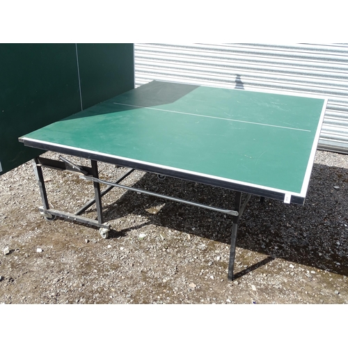 834 - A folding table tennis table with wheeled base, the top approx 108