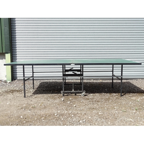 834 - A folding table tennis table with wheeled base, the top approx 108