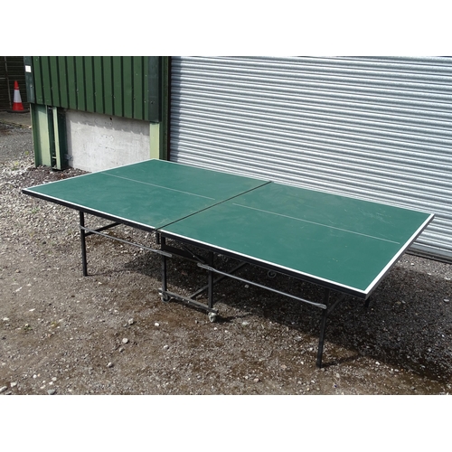 834 - A folding table tennis table with wheeled base, the top approx 108