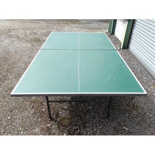 834 - A folding table tennis table with wheeled base, the top approx 108