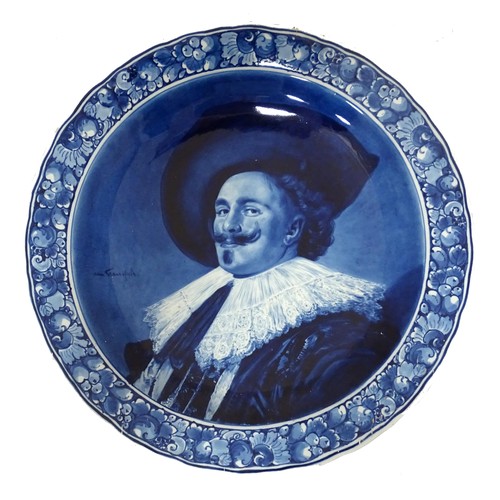 An early 20thC Joost Thooft & Labouchere (Royal Delft) Delft circular wall charger depicting The Laughing Cavalier after Frans Hals. Approx. 15 3/4" diameter