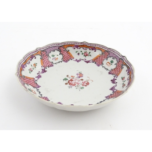 17 - A Chinese Export plate decorated with flowers and foliate with a scrolling border. Approx. 5 1/2