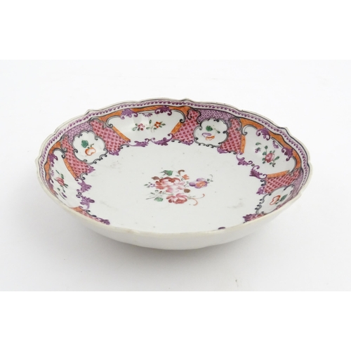 17 - A Chinese Export plate decorated with flowers and foliate with a scrolling border. Approx. 5 1/2