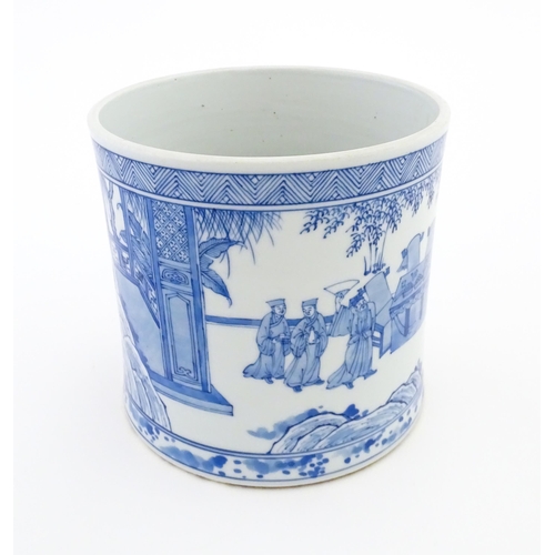 36 - A Chinese blue and white vase / planter decorated with figures in a garden setting with a feast, and... 