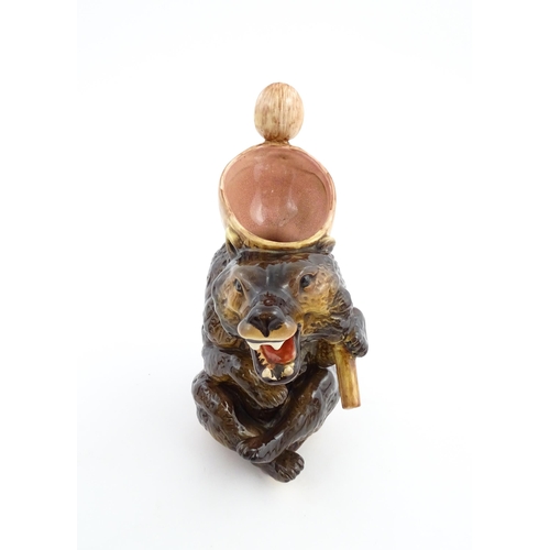 70 - A majolica bear jug modelled as a seated brown bear holding a honey pot and spoon. In the manner of ... 