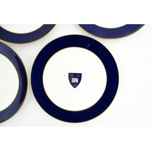 138 - Seven Royal Worcester armorial plates to include two bearing the Cambridge University coat of arms, ... 