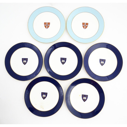 138 - Seven Royal Worcester armorial plates to include two bearing the Cambridge University coat of arms, ... 