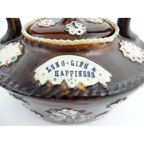 152 - A Victorian Measham bargeware teapot with floral and foliate motifs and motto Long Life & Happiness.... 