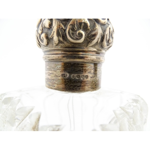 213 - A pair of Victorian cut glass scent bottles of squared form with glass stoppers and silver tops hall... 