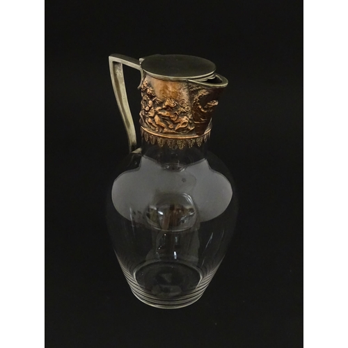 239 - An early 20thC glass claret jug with silver plate mount and handle depicting Bacchanalian figures. A... 