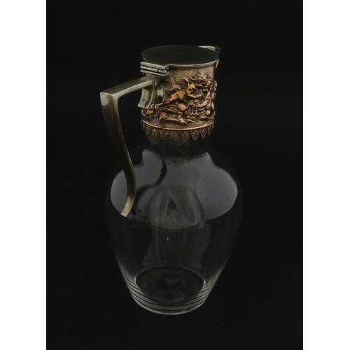 239 - An early 20thC glass claret jug with silver plate mount and handle depicting Bacchanalian figures. A... 