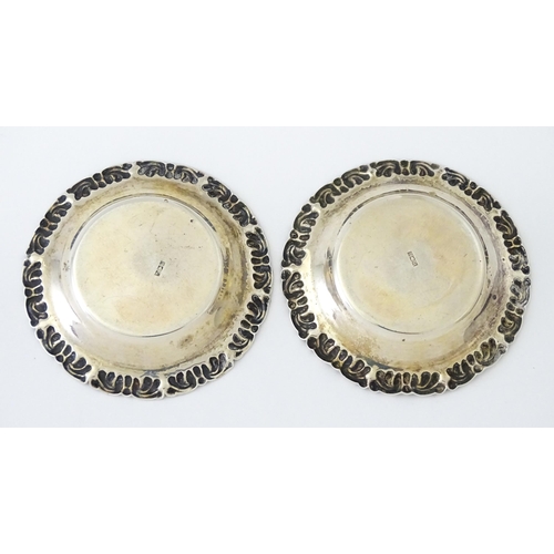 449 - A pair of cut glass salts on Egyptian silver stands together with two salt spoons hallmarked Sheffie... 