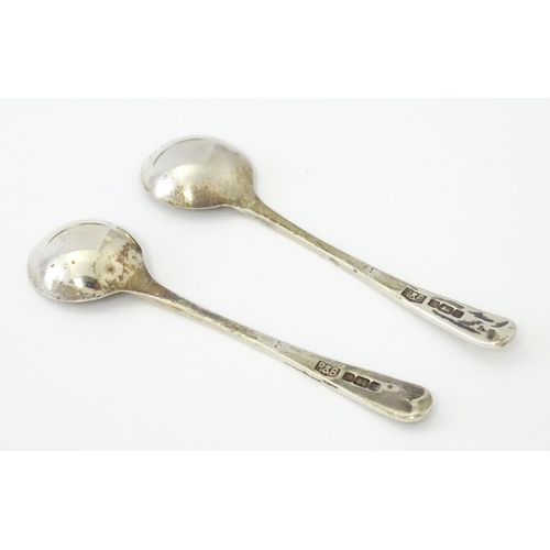 449 - A pair of cut glass salts on Egyptian silver stands together with two salt spoons hallmarked Sheffie... 