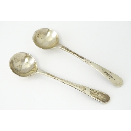 449 - A pair of cut glass salts on Egyptian silver stands together with two salt spoons hallmarked Sheffie... 