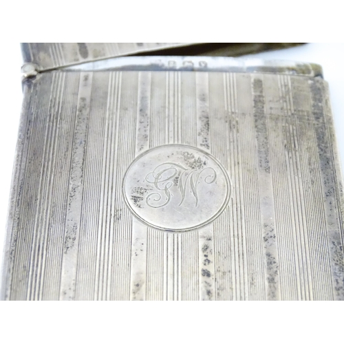 451 - A silver card case with banded engine turned decoration. Hallmarked Birmingham 1920 maker William Ne... 