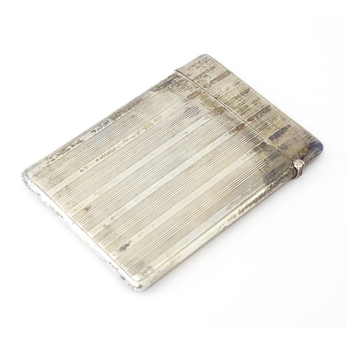 451 - A silver card case with banded engine turned decoration. Hallmarked Birmingham 1920 maker William Ne... 