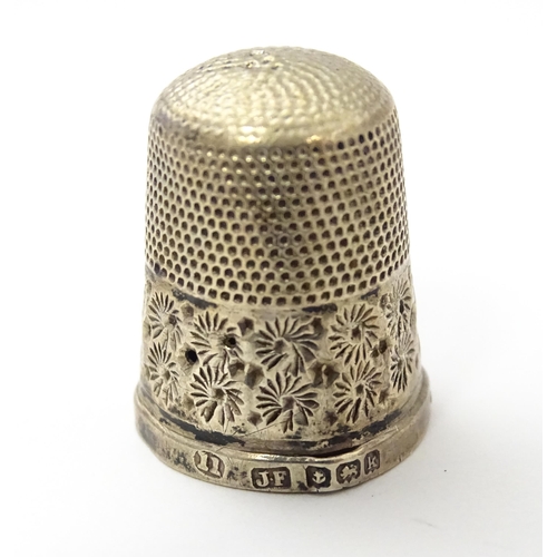 468 - Two silver thimbles with floral decoration, comprising a Victorian example hallmarked Chester 1890, ... 