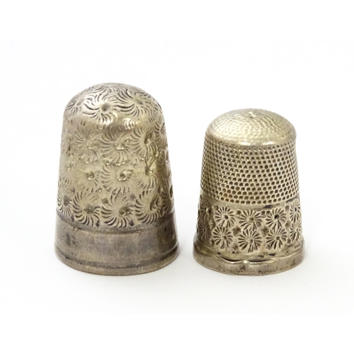 468 - Two silver thimbles with floral decoration, comprising a Victorian example hallmarked Chester 1890, ... 