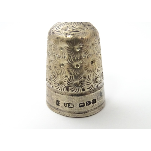 468 - Two silver thimbles with floral decoration, comprising a Victorian example hallmarked Chester 1890, ... 