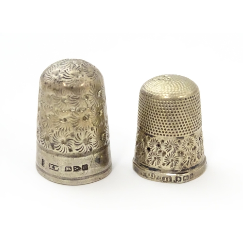 468 - Two silver thimbles with floral decoration, comprising a Victorian example hallmarked Chester 1890, ... 