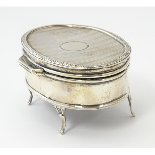 499 - A silver ring box of oval form with engine turned decoration, hallmarked Birmingham 1921, maker E S ... 