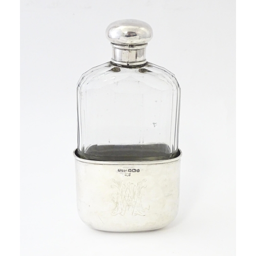 502 - A glass hip flask with silver top, with associated silver beaker lower hallmarked Sheffield 1894, ma... 