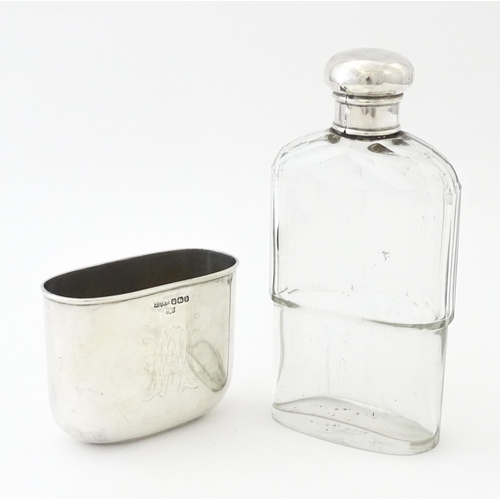 502 - A glass hip flask with silver top, with associated silver beaker lower hallmarked Sheffield 1894, ma... 