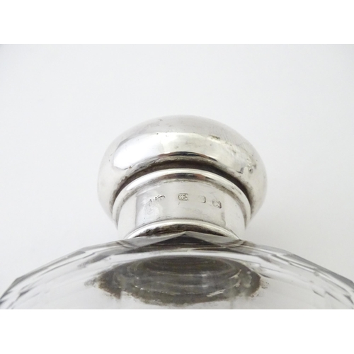 502 - A glass hip flask with silver top, with associated silver beaker lower hallmarked Sheffield 1894, ma... 