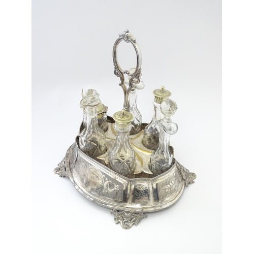 572 - A silver plate cruet stand with six various cut glass cruet bottles. Approx. 12