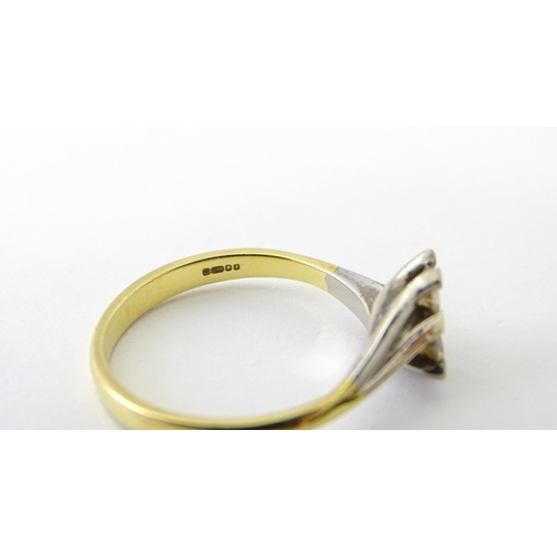 602 - An 18ct gold ring set with two diamonds. Ring size approx. O