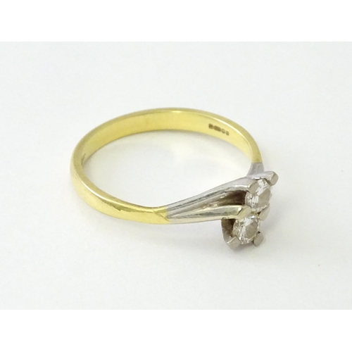 602 - An 18ct gold ring set with two diamonds. Ring size approx. O