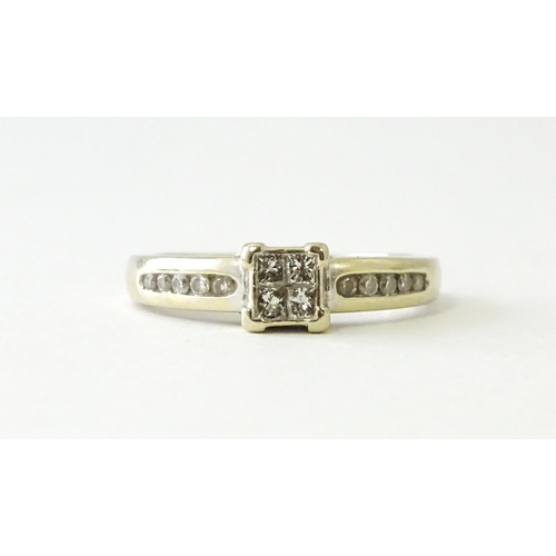 607 - An 18ct white gold ring set with four central diamonds in a square setting, flanked by five channel ... 