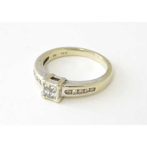 607 - An 18ct white gold ring set with four central diamonds in a square setting, flanked by five channel ... 