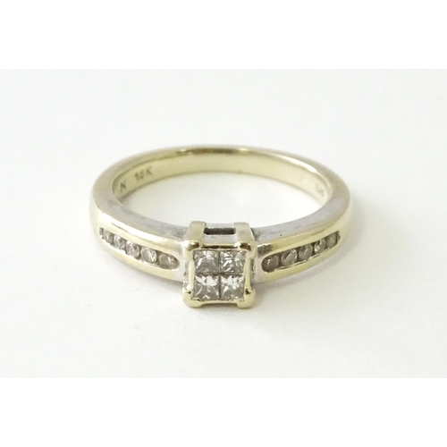 607 - An 18ct white gold ring set with four central diamonds in a square setting, flanked by five channel ... 