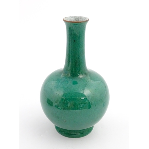 1 - A Chinese bottle vase with green crackle glaze. Approx. 9 1/2