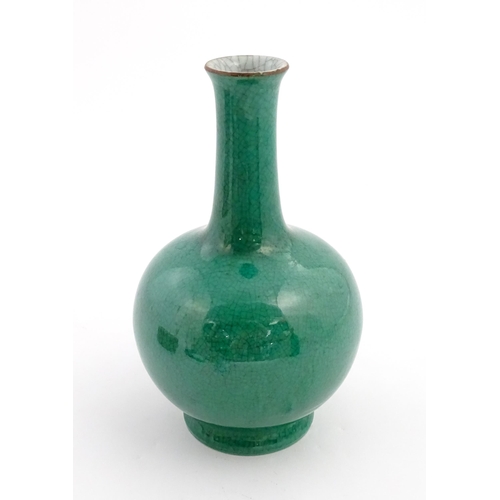 1 - A Chinese bottle vase with green crackle glaze. Approx. 9 1/2