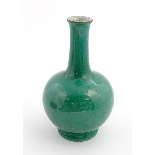 1 - A Chinese bottle vase with green crackle glaze. Approx. 9 1/2