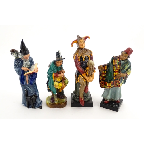 104 - Four Royal Doulton figures comprising The Jester HN2016, The Wizard HN2877, The Mask Seller HN2103, ... 