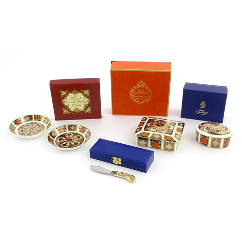 109 - A quantity of Royal Crown Derby items to include trinket boxes, pin dishes and a butter knife. Large... 