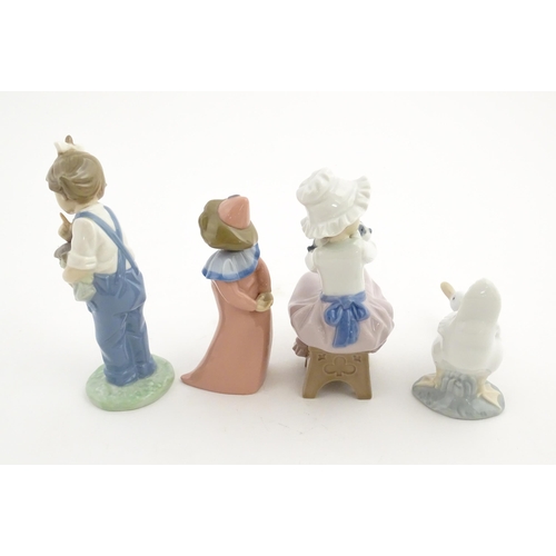 113 - Four Nao figurines comprising Hush Now no. 1069, Timid Pierrot no. 1031, A Big Hug no. 1049, and a d... 