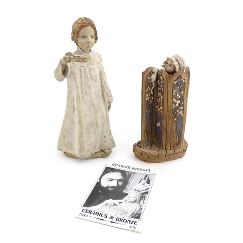 122 - Two studio pottery figurines by Graham Piggott of Blandon Pottery, one modelled as a child in a nigh... 