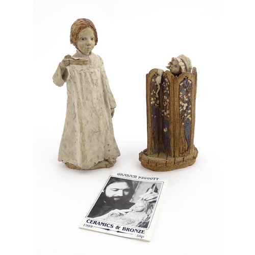 122 - Two studio pottery figurines by Graham Piggott of Blandon Pottery, one modelled as a child in a nigh... 