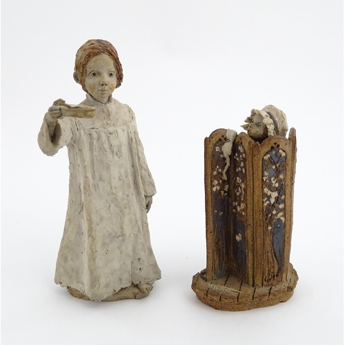 122 - Two studio pottery figurines by Graham Piggott of Blandon Pottery, one modelled as a child in a nigh... 