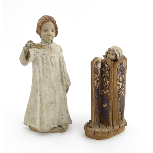 122 - Two studio pottery figurines by Graham Piggott of Blandon Pottery, one modelled as a child in a nigh... 