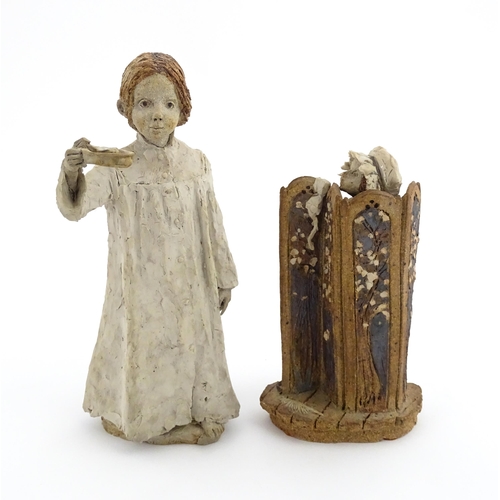 122 - Two studio pottery figurines by Graham Piggott of Blandon Pottery, one modelled as a child in a nigh... 